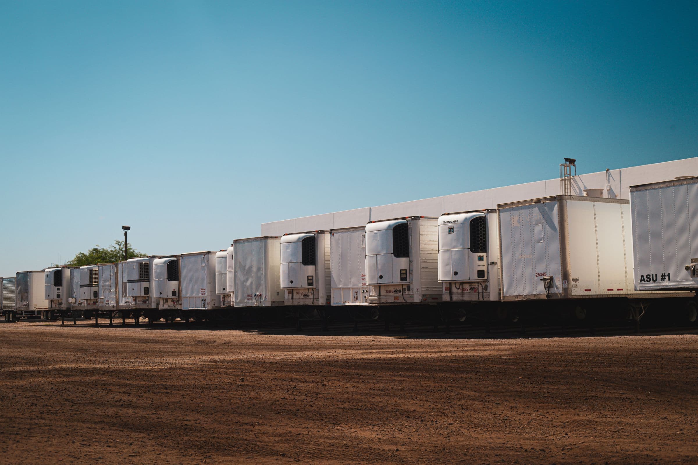 Refrigerated trailers lined up at a depot